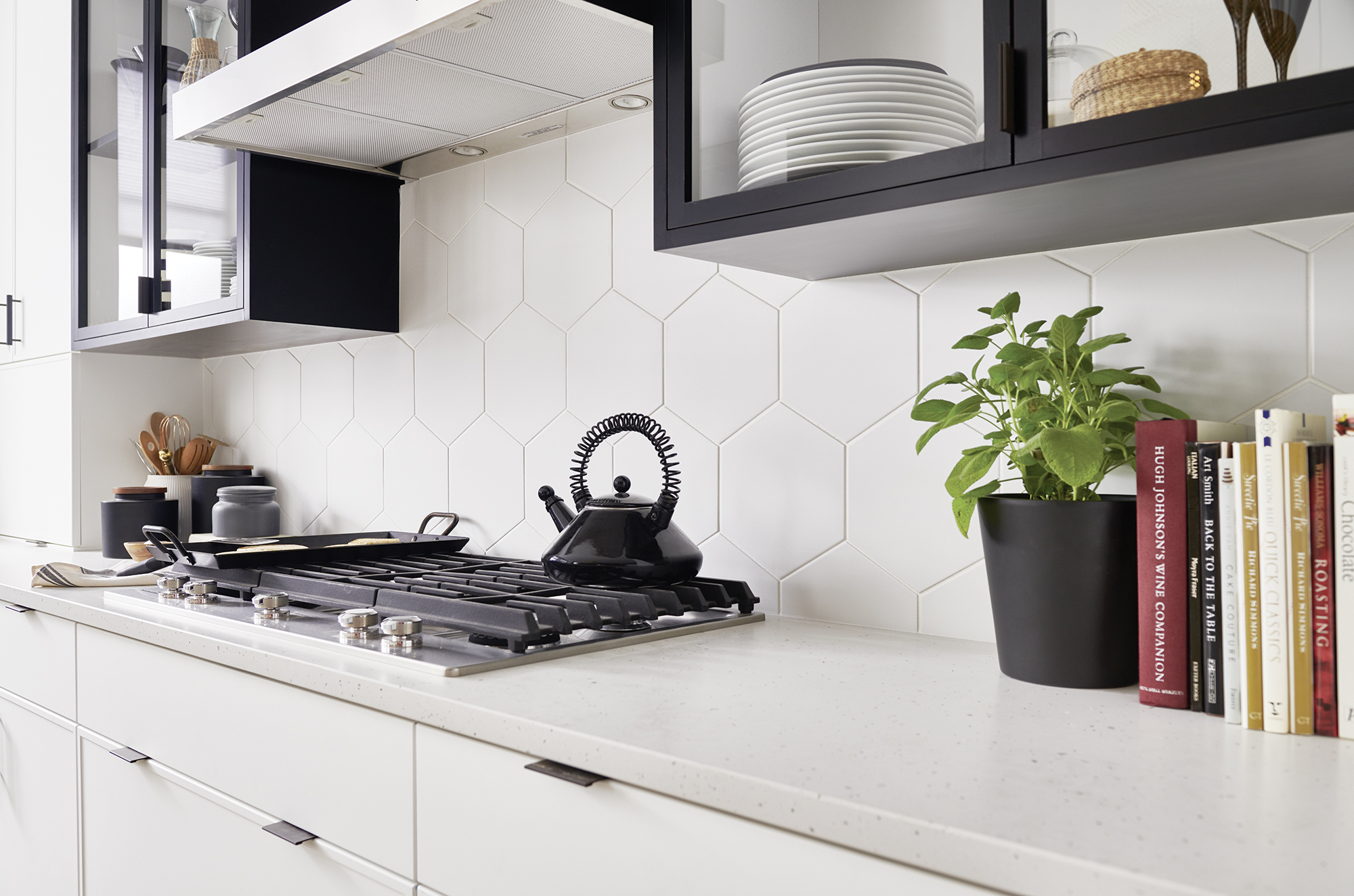 In a modern white kitchen, furniture and décor provide natural, warm elements