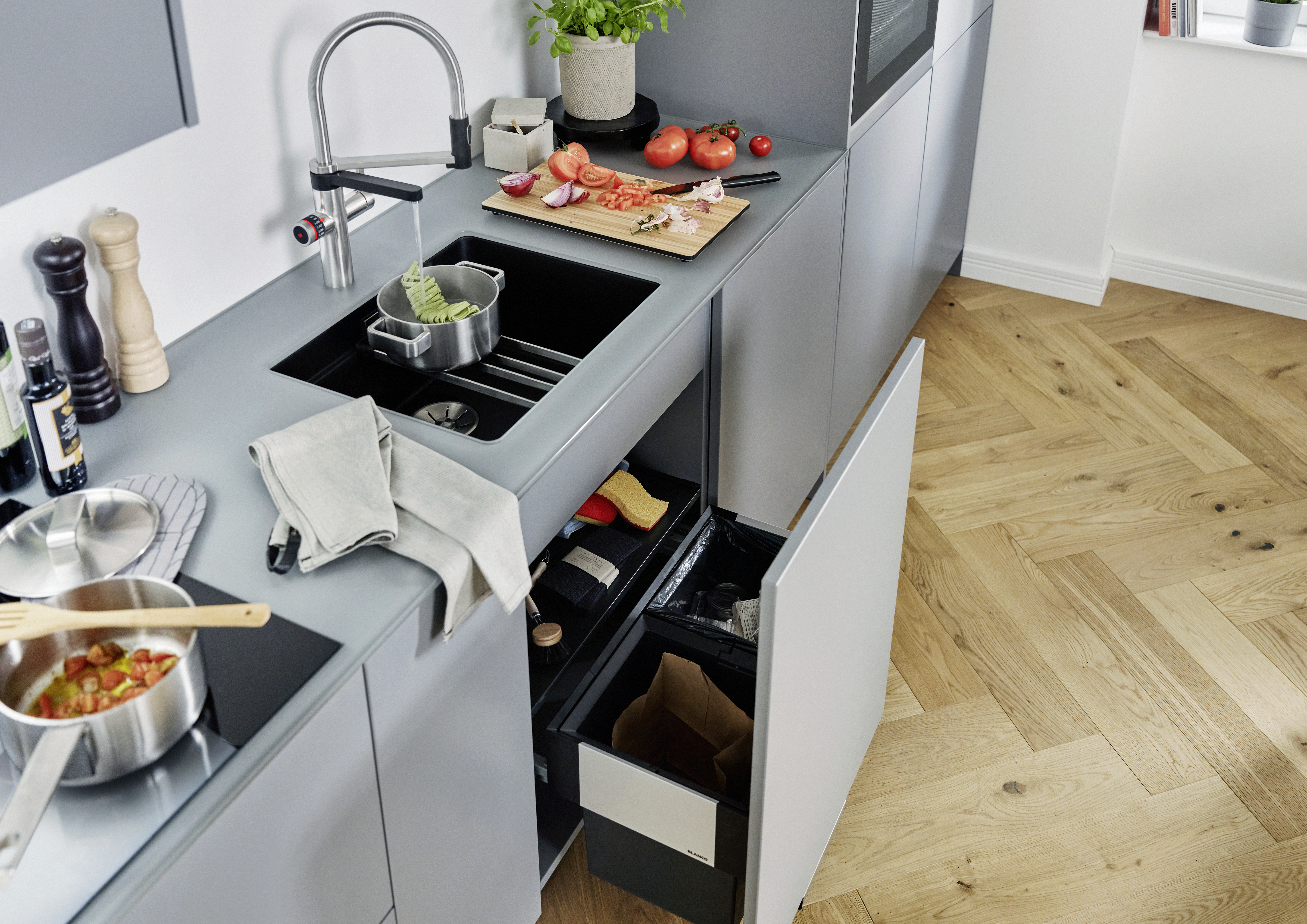 Base cabinet with waste system