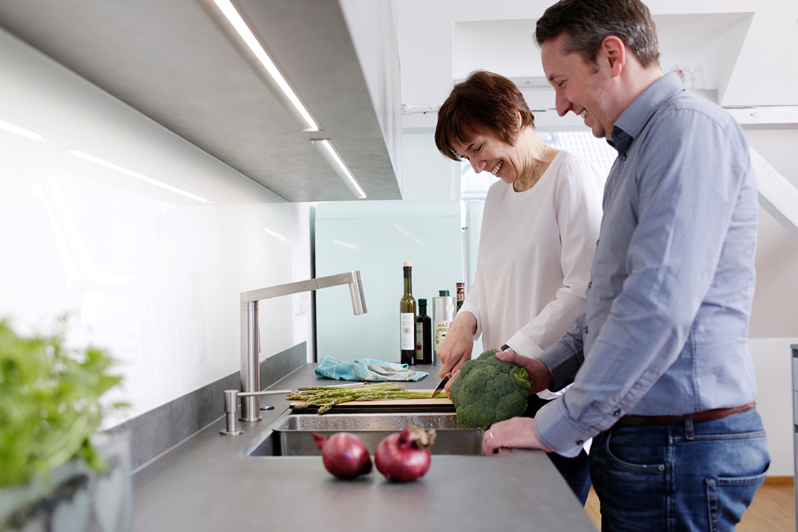Couple cooking at a flushmount sink