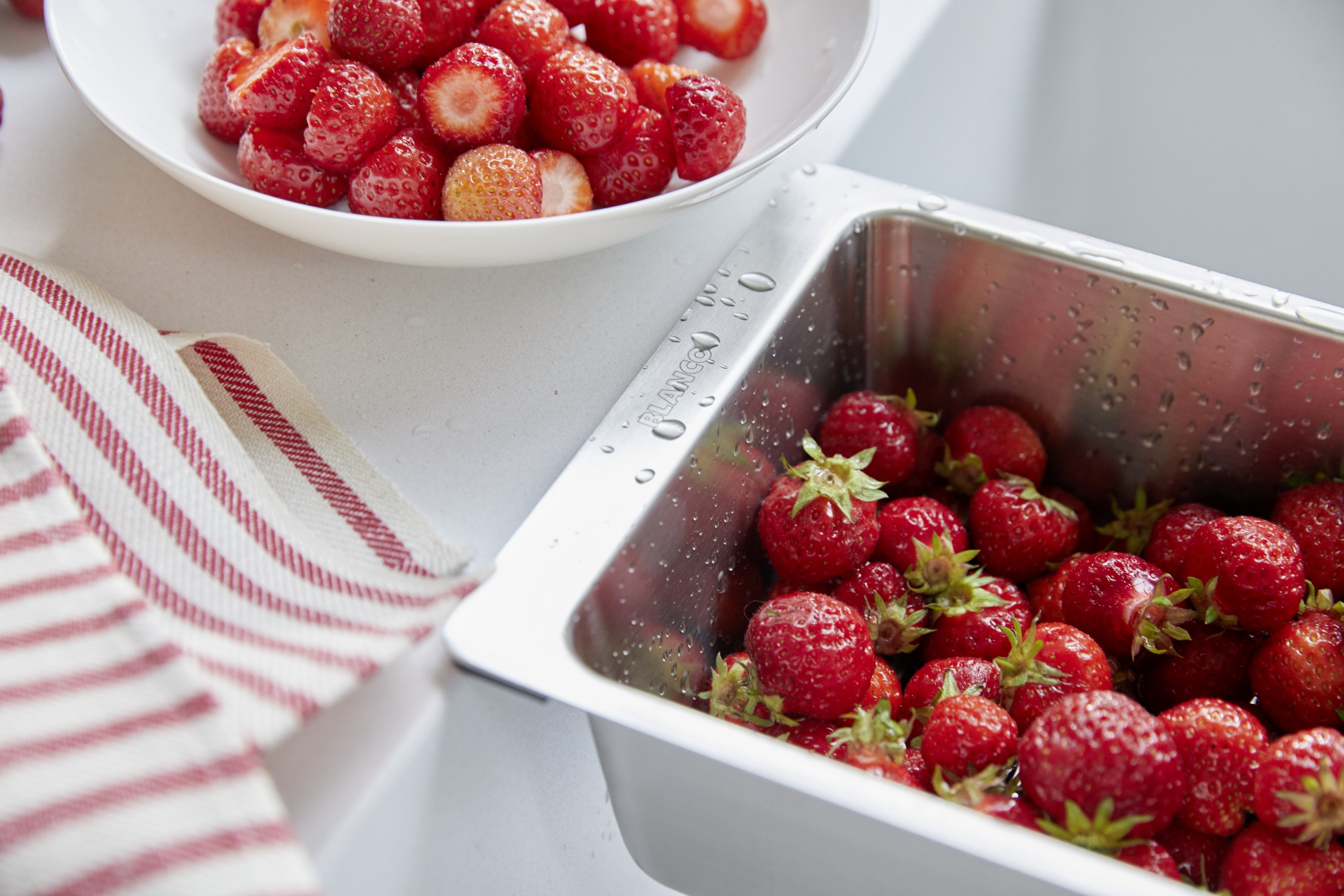 A young girl makes pancakes with her mother