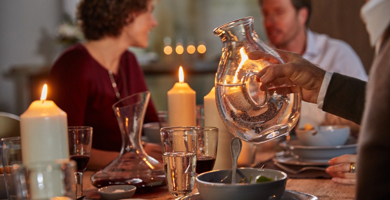 A man holds a vessel of water in his hand