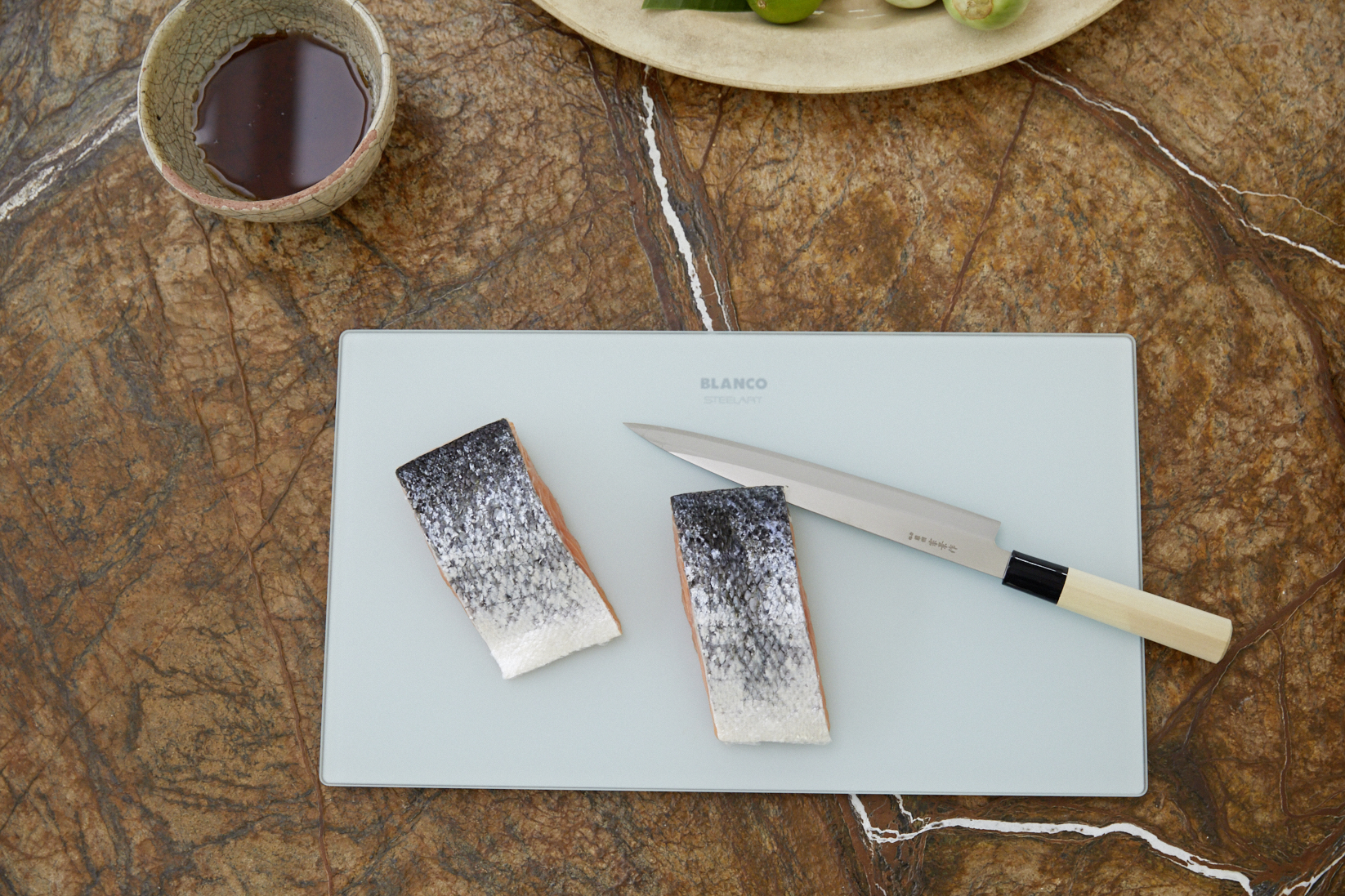 Raw salmon, cut on a BLANCO cutting board