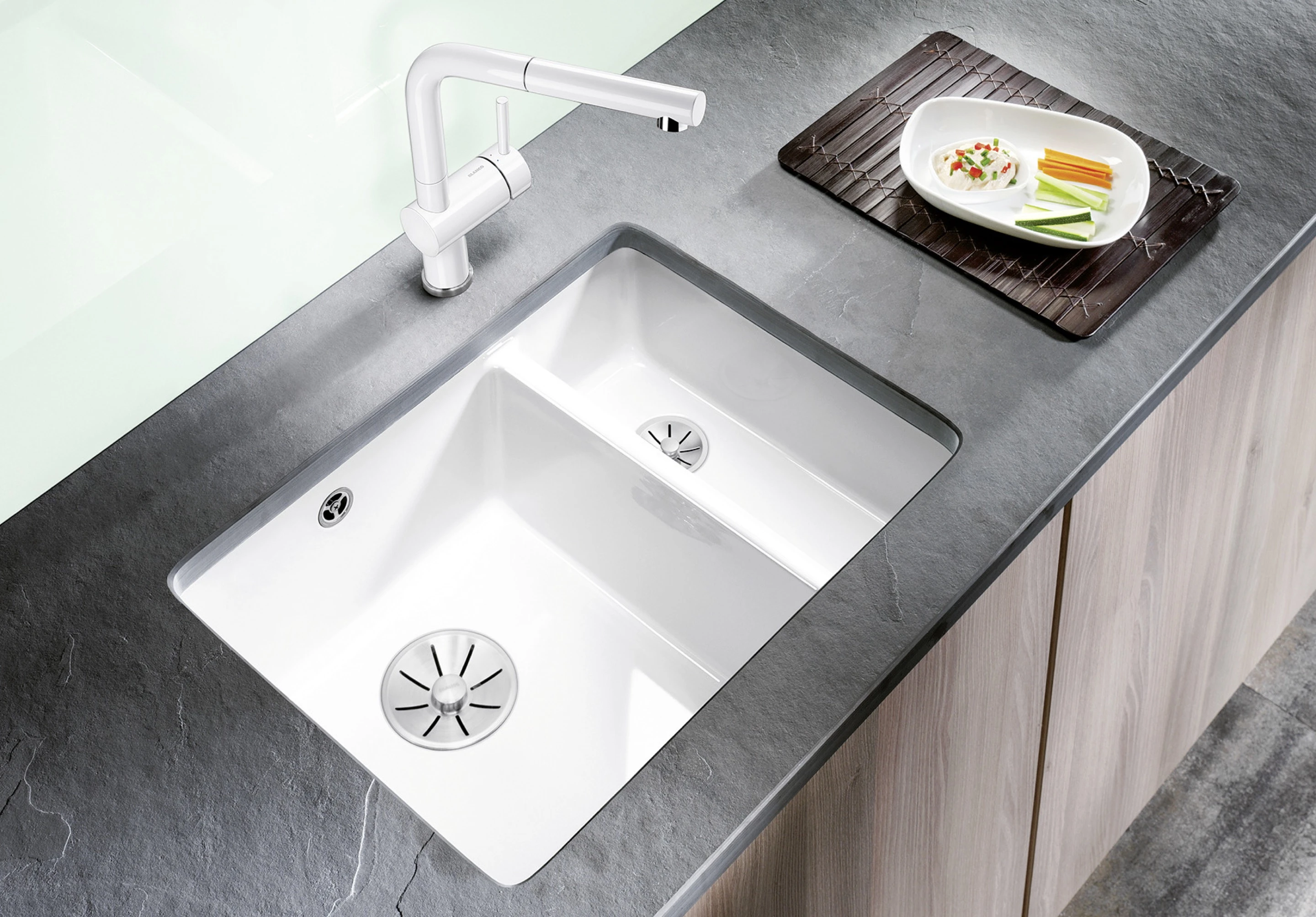 Woman standing at an undermount sink