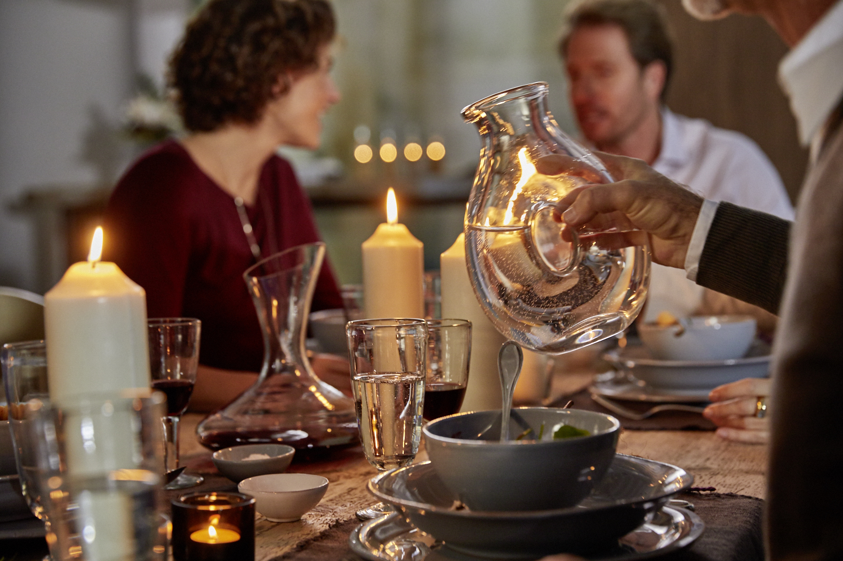 a man holds a water carafe in his hand