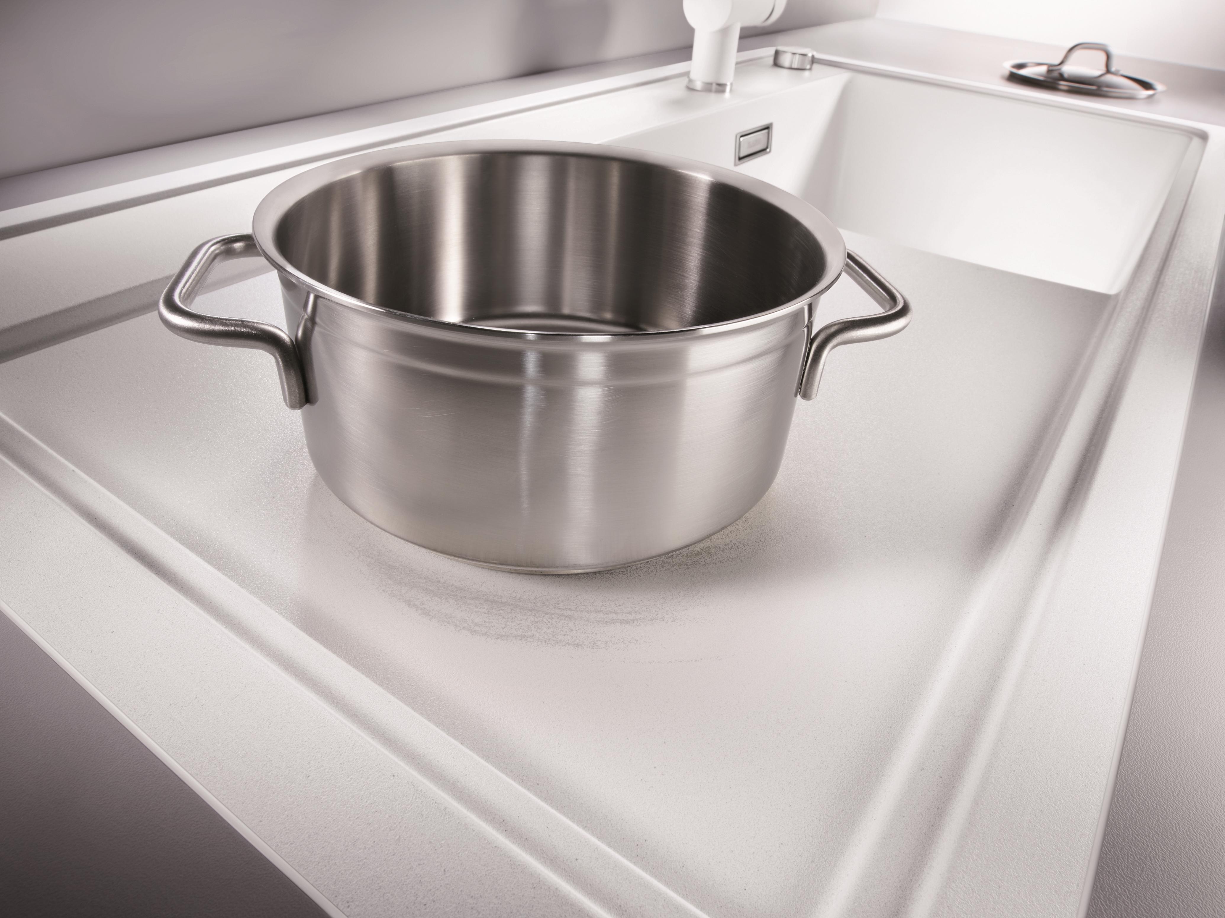 Metal abrasion on a white silgranit sink