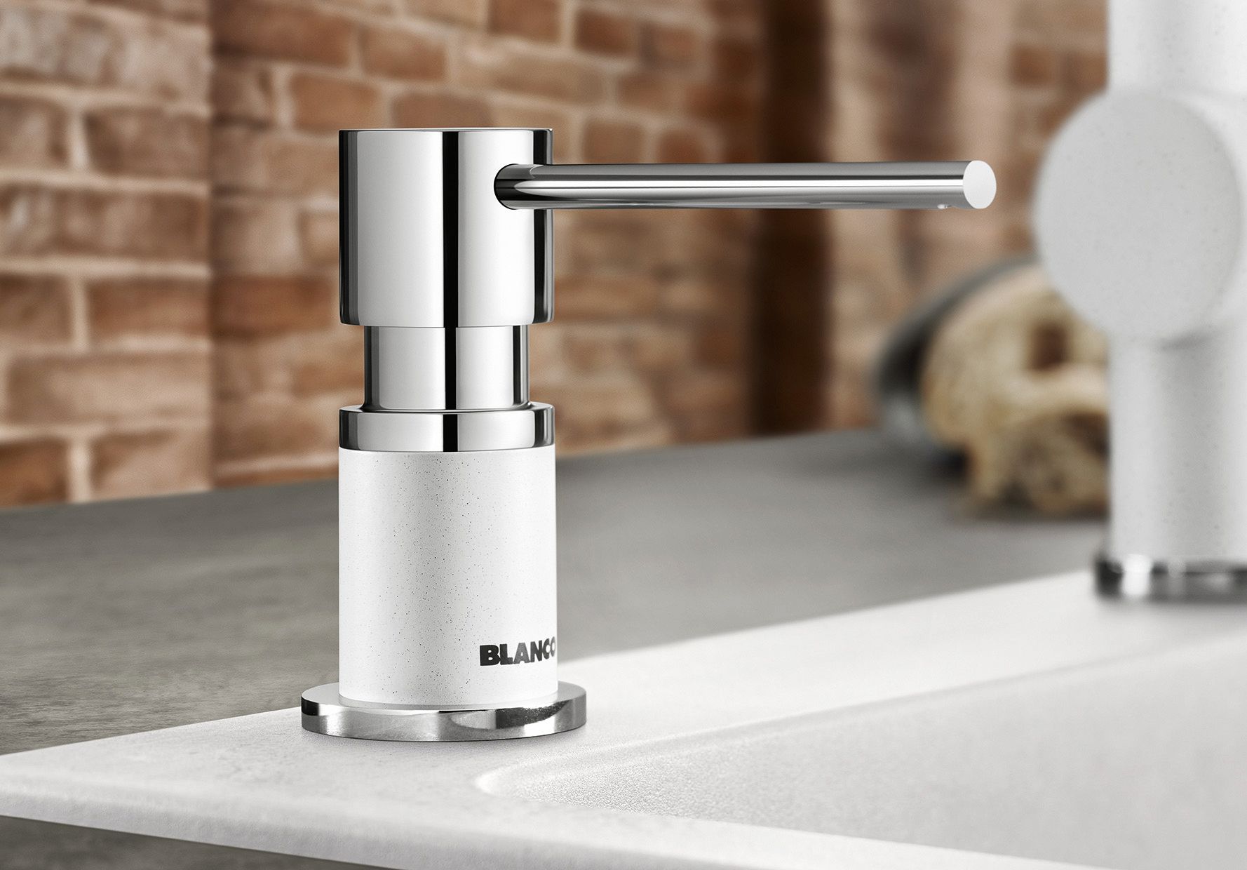 Only the pump button of the soap bottle stands out from the edge of the sink