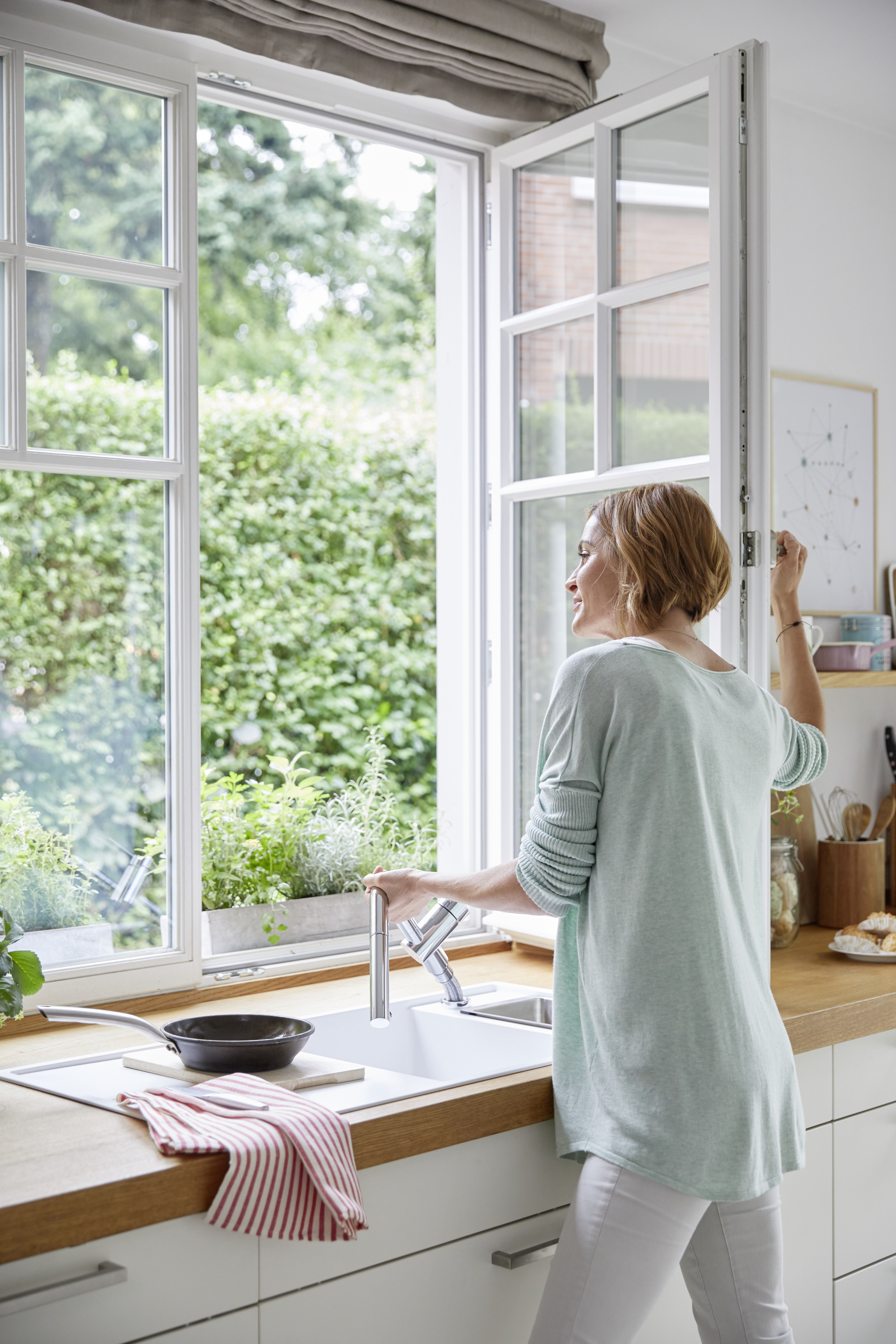 Make the most of the nicest place in the kitchen with a below-window mixer tap.